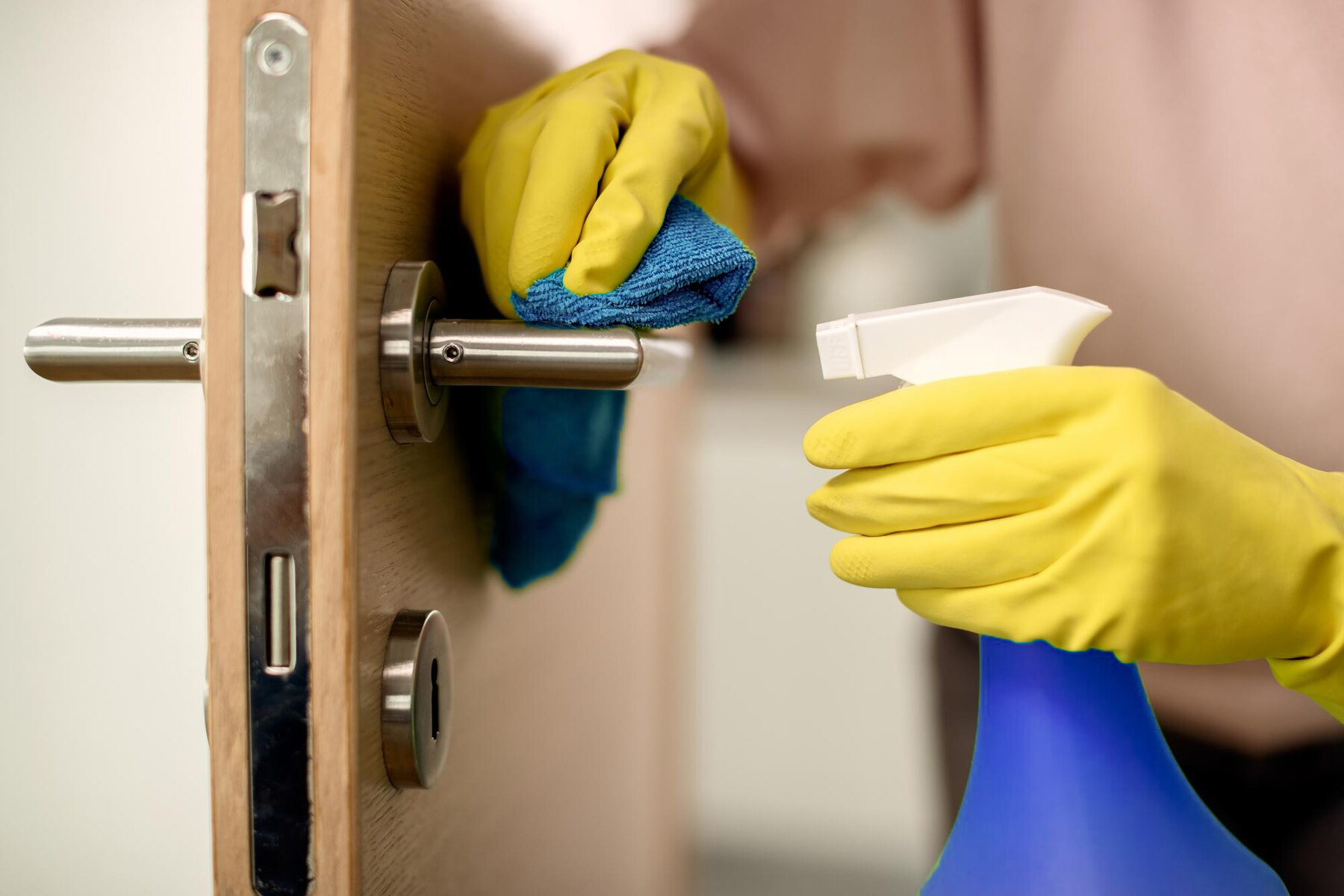 cloeup-woman-disinfecting-door-handle-home_637285-8522